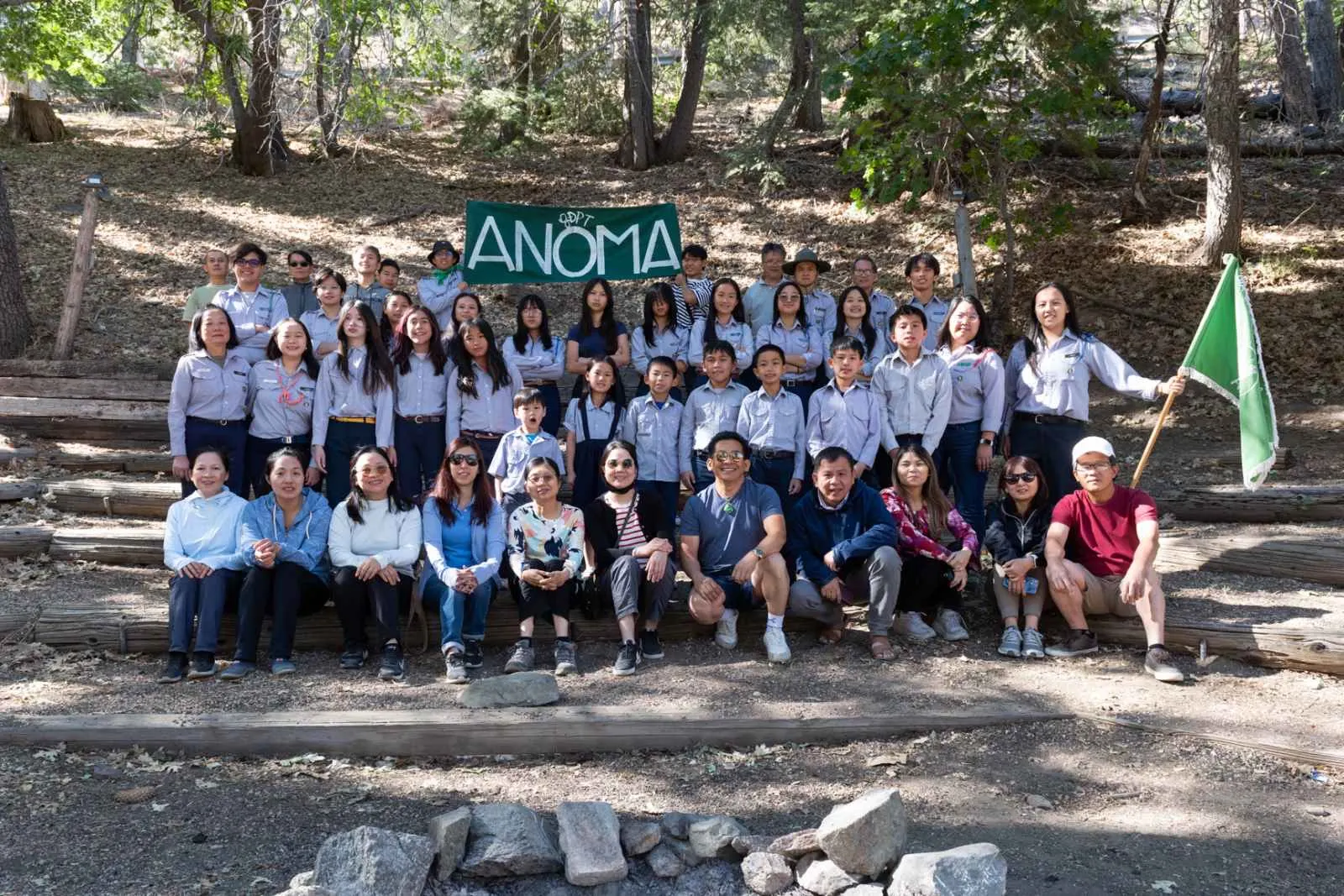 GĐPT Anôma members in blue uniforms with the chapter banner